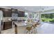 Modern kitchen with granite countertops, stainless steel appliances, and an open layout to the living area at 11412 Velvet Apricot Dr, Land O Lakes, FL 34638