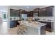 Modern kitchen featuring granite countertops, stainless steel appliances, and bar stool seating at 11415 Velvet Apricot Dr, Land O Lakes, FL 34638