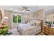Main bedroom with large bed, accent wall, and natural light from a large window at 11415 Velvet Apricot Dr, Land O Lakes, FL 34638