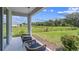 Covered patio overlooking a beautiful green lawn and treed backyard at 11415 Velvet Apricot Dr, Land O Lakes, FL 34638