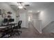Hallway featuring neutral paint, plush carpet, white doors, and a home office setup with a modern desk at 11704 Castine St, New Port Richey, FL 34654