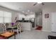 Open-concept kitchen and dining area with white cabinetry, stainless steel appliances, and ample counter space at 11704 Castine St, New Port Richey, FL 34654