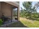 Relaxing screened porch with a view of the lush backyard and natural landscape at 11704 Castine St, New Port Richey, FL 34654