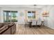 Dining room area featuring hardwood flooring, neutral colored walls and plenty of natural light at 12916 Brookside Moss Dr, Riverview, FL 33579