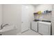 Functional laundry room featuring modern washer and dryer and storage at 12916 Brookside Moss Dr, Riverview, FL 33579
