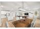 Bright, open concept living space features modern light fixtures, hardwood flooring, and lots of natural light at 12916 Brookside Moss Dr, Riverview, FL 33579