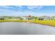 Back of the house featuring a serene water view and white picket fencing, offering privacy and charm at 12916 Brookside Moss Dr, Riverview, FL 33579