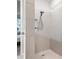 Bright shower with a rainfall shower head, niche and light tile surround at 12916 Brookside Moss Dr, Riverview, FL 33579
