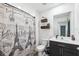 Well-lit bathroom showcasing a vanity with sink, toilet, and a shower with decorative curtain at 14100 Holly Hammock Ln, Brooksville, FL 34613