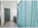 Clean bathroom featuring a blue shower curtain, white walls and modern vanity at 14100 Holly Hammock Ln, Brooksville, FL 34613