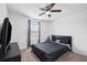 Comfortable bedroom with a ceiling fan, TV set, carpet flooring, and a window for natural light at 14100 Holly Hammock Ln, Brooksville, FL 34613