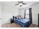 Cozy bedroom featuring a ceiling fan, carpet flooring, and a window for natural light at 14100 Holly Hammock Ln, Brooksville, FL 34613