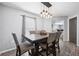 A beautifully decorated dining room with modern lighting and seating at 14100 Holly Hammock Ln, Brooksville, FL 34613