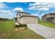 Inviting two-story home featuring a well-manicured lawn and a two-car garage at 14100 Holly Hammock Ln, Brooksville, FL 34613