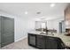 This open kitchen features a wine cooler and granite countertops at 14100 Holly Hammock Ln, Brooksville, FL 34613