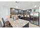 Modern kitchen featuring granite countertops, stainless steel appliances, and breakfast bar seating at 14100 Holly Hammock Ln, Brooksville, FL 34613