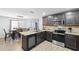 A fully equipped kitchen with stainless steel appliances and an adjacent dining area at 14100 Holly Hammock Ln, Brooksville, FL 34613
