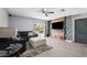 Modern living room with sleek wood floors, sectional sofa, and decorative wood accent wall at 14100 Holly Hammock Ln, Brooksville, FL 34613