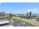 A view of a coastal community from above with a road, palm trees, cars, and an ocean view at 1460 Gulf Blvd # 509, Clearwater Beach, FL 33767