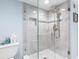 This spa-like bathroom features a frameless glass shower and upgraded shower fixture at 1460 Gulf Blvd # 509, Clearwater Beach, FL 33767