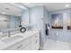 Contemporary bathroom featuring a sleek vanity, a large mirror, and a glass-enclosed shower at 1460 Gulf Blvd # 509, Clearwater Beach, FL 33767