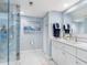 Modern bathroom with glass shower, double sinks, and elegant decor, exuding comfort and style at 1460 Gulf Blvd # 509, Clearwater Beach, FL 33767