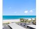 Overhead shot of the beach, turquoise water, and white sand from a high-rise condo on a sunny day at 1460 Gulf Blvd # 509, Clearwater Beach, FL 33767