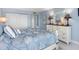Bright bedroom with seaside decor, comfortable bed, and stylish dresser, creating a tranquil retreat at 1460 Gulf Blvd # 509, Clearwater Beach, FL 33767
