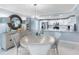 Bright dining room features a modern chandelier and a breakfast bar that opens to the kitchen with white cabinetry at 1460 Gulf Blvd # 509, Clearwater Beach, FL 33767