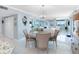 Coastal dining room with seating for three, modern light fixture, and water views at 1460 Gulf Blvd # 509, Clearwater Beach, FL 33767