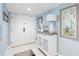 Light-blue hallway with artwork, console table, lamp, and decorative pieces at 1460 Gulf Blvd # 509, Clearwater Beach, FL 33767