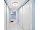 Bright hallway with white marble flooring and white closets leading to a well lit bedroom at 1460 Gulf Blvd # 509, Clearwater Beach, FL 33767