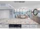 Bright, airy kitchen with granite countertops, modern appliances, and pendant lighting flowing into an open living space at 1460 Gulf Blvd # 509, Clearwater Beach, FL 33767