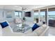 Living room area with contemporary furniture, sliding glass doors to the balcony, and natural light at 1460 Gulf Blvd # 509, Clearwater Beach, FL 33767