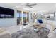 Bright and airy living room with tile floors, modern furnishings, and water views at 1460 Gulf Blvd # 509, Clearwater Beach, FL 33767