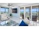 Living room boasting sliding glass doors with ocean views, comfortable seating, and neutral tones at 1460 Gulf Blvd # 509, Clearwater Beach, FL 33767