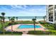 Enjoy the outdoors with this pool surrounded by palm trees and beach views at 1460 Gulf Blvd # 509, Clearwater Beach, FL 33767