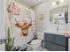 A charming bathroom featuring modern vanity and a whimsical cow-themed shower curtain at 14910 Par Club Cir, Tampa, FL 33618