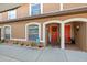 Inviting townhouse entrance featuring colorful doors, arched entryways, and neat landscaping at 14910 Par Club Cir, Tampa, FL 33618
