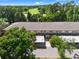 Charming exterior of the building with carport and lush green landscaping with golf course in the background at 14910 Par Club Cir, Tampa, FL 33618