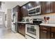 Well-equipped kitchen with stainless appliances, dark cabinets, and subway tile backsplash at 14910 Par Club Cir, Tampa, FL 33618