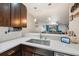 Modern kitchen featuring quartz countertops, stainless steel sink, and stylish backsplash at 14910 Par Club Cir, Tampa, FL 33618