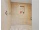 Tiled shower with shampoo niche and bench at 14910 Par Club Cir, Tampa, FL 33618