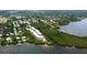 Stunning aerial view of a waterfront community with lush greenery, showcasing the desirable coastal lifestyle at 1500 Sunset Rd # F8, Tarpon Springs, FL 34689