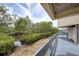 Relaxing back deck with a scenic view of lush greenery and tranquil water, offering a serene outdoor experience at 1500 Sunset Rd # F8, Tarpon Springs, FL 34689