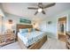 Bright and airy bedroom with coastal decor, featuring a king-size bed and a ceiling fan at 1500 Sunset Rd # F8, Tarpon Springs, FL 34689