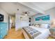 Comfortable bedroom with a ceiling fan, hardwood floors, light walls, washer and dryer in the closet, and coastal accents at 1500 Sunset Rd # F8, Tarpon Springs, FL 34689