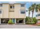Charming two-story townhouse with tropical landscaping and covered parking at 1500 Sunset Rd # F8, Tarpon Springs, FL 34689