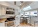 Charming kitchen nook with a breakfast bar, skylight, stainless appliances and a view of the neighborhood at 1500 Sunset Rd # F8, Tarpon Springs, FL 34689