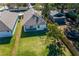 An aerial shot of the backyard, showing a well-maintained lawn, privacy fence, and patio area at 1808 E Comanche Ave, Tampa, FL 33610